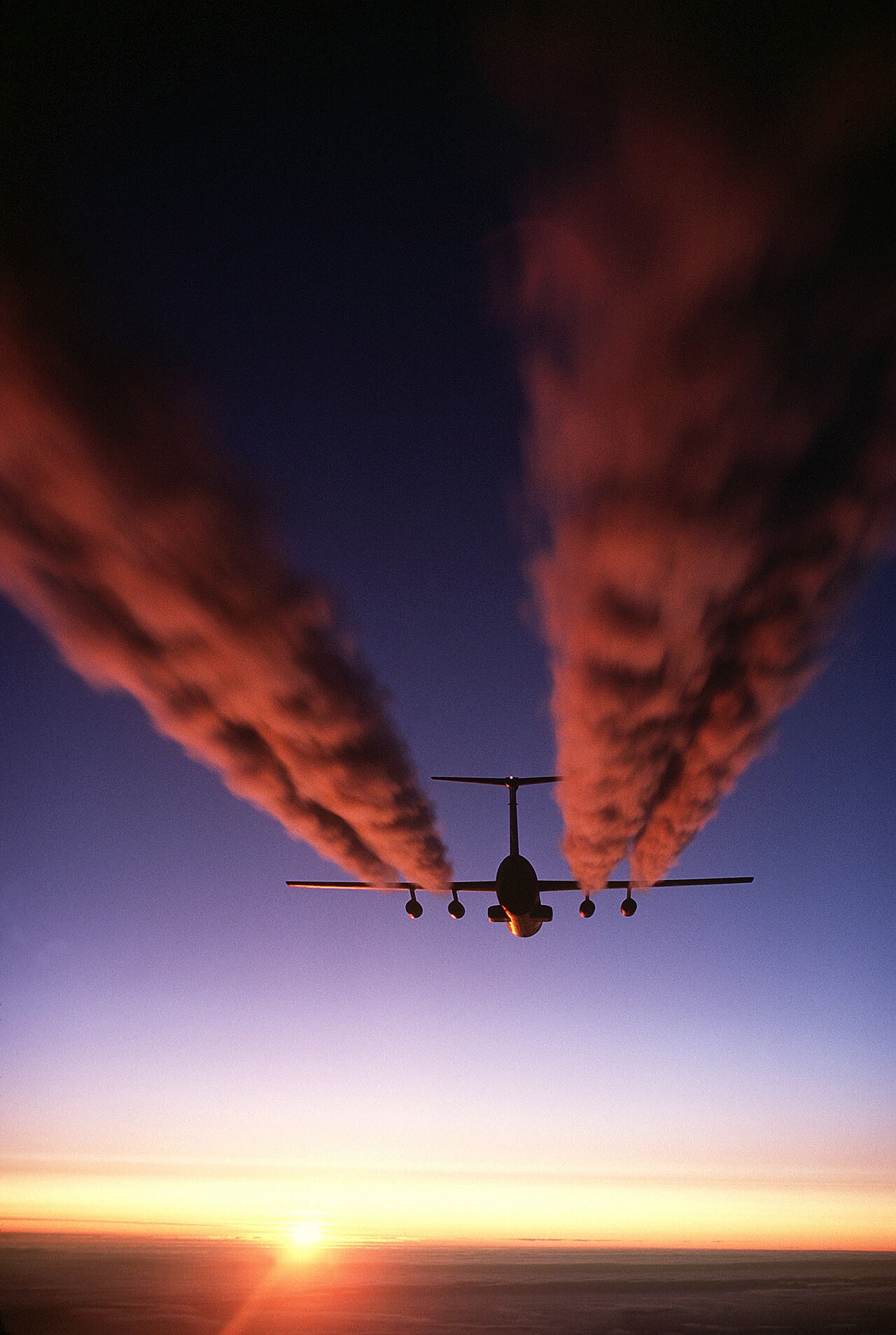 C-141 aircraft leaving contrails above Antarctica